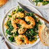 Garlic-butter and white-wine prawns over wilted spinach.