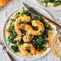 Garlic-butter and white-wine prawns over wilted spinach.