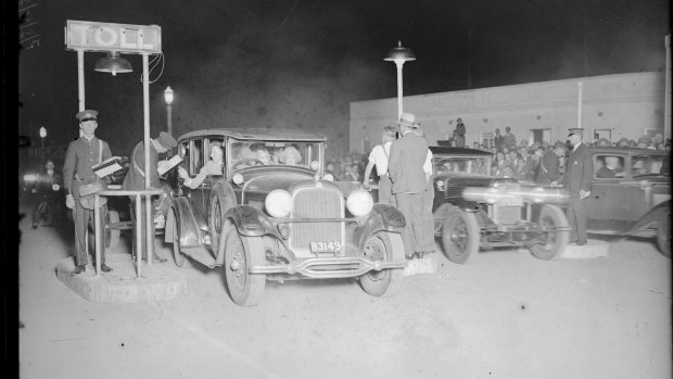 The first cars cross the newly opened Sydney Harbour Bridge. 