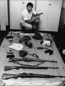 Det. Sgt. Geoff McDowell with weapons and other gear found in Dennings’ flat. November 9, 1981.