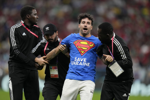 A protester is removed during the match between Portugal and Uruguay at the Lusail Stadium, Qatar, on Monday.