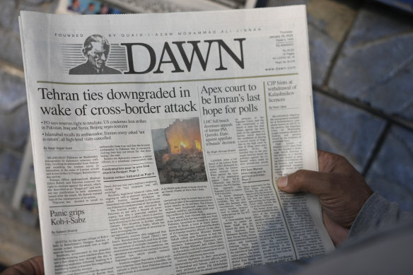 A Pakistani reads the front page of a morning newspaper covering Iran’s strike, at a stall in Islamabad, Pakistan, on Thursday.