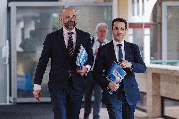 Premier David Crisafulli and Treasurer David Janetzki holding Queensland’s budget papers on Tuesday.