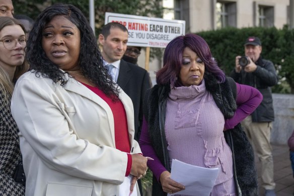 Wandrea “Shaye” Moss, left, and her mother Ruby Freeman, right, leave after speaking with reporters outside federal court.