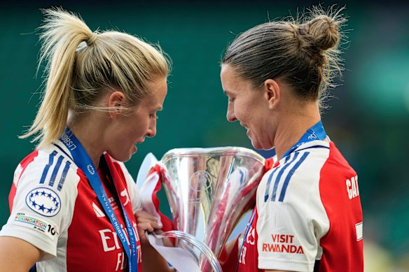 Arsenal’s Leah Williamson and Steph Catley holding the winner trophy defeating FC Barcelona on Saturday.