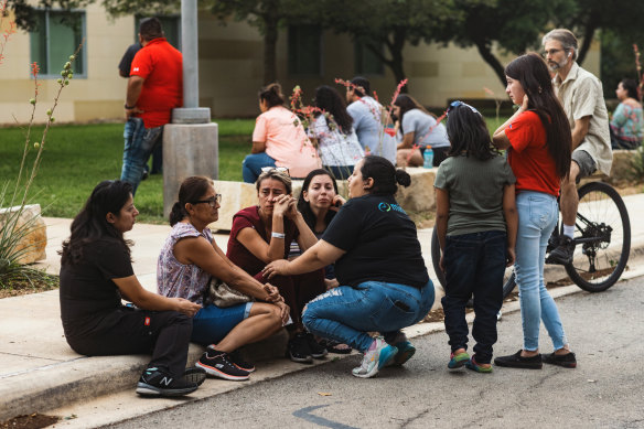 People grieve outside the SSGT Willie de Leon Civic Centre after a school shooting in Texas.