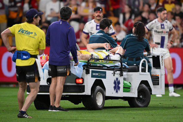 Ryan Papenhuyzen of the Storm is taken off the field after an ankle injury.