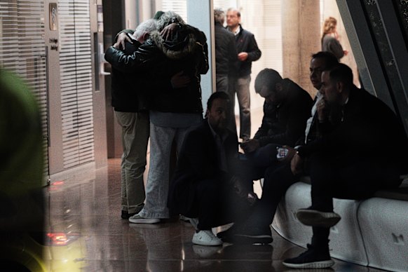 Miguel Uribe Turbay’s father (top left) embraces relatives outside the hospital where his son was being treated.