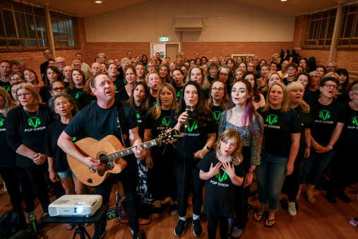 Big family: A Pop Choir rehearsal in Moorabbin with (front) Darryl Moulton, with guitar, wife Sharon Stokes, with microphone, and their daughter, Piper, 7, standing in front of choir member Eleanor Chadwick.