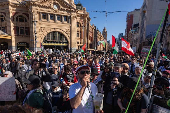 Pro-Palestine demonstrators march past Flinders Street Station on Sunday.