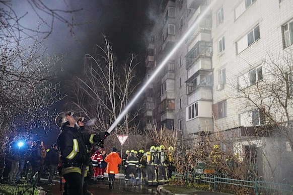 Firefighters put out a blaze after a Russian attack in Vyshgorod, outside of Kyiv, on Sunday.