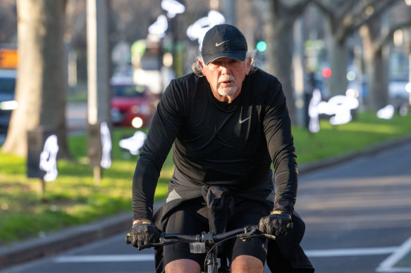 Developer John Woodman rides along St Kilda Road ahead of the IBAC report being tabled on Thursday.