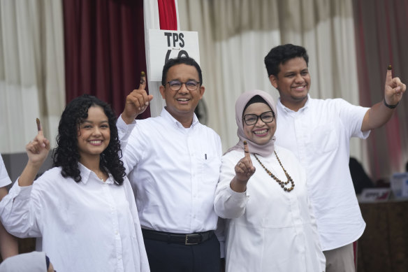 Anies Baswedan (second left) and his family after casting their vote in Jakarta. 
