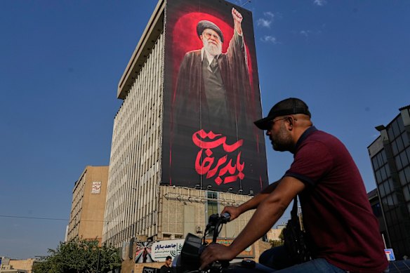 A Tehran billboard with a message that reads in Farsi, “We must rise up”, and an image of the late Iranian supreme leader Ayatollah Ali Khamenei.