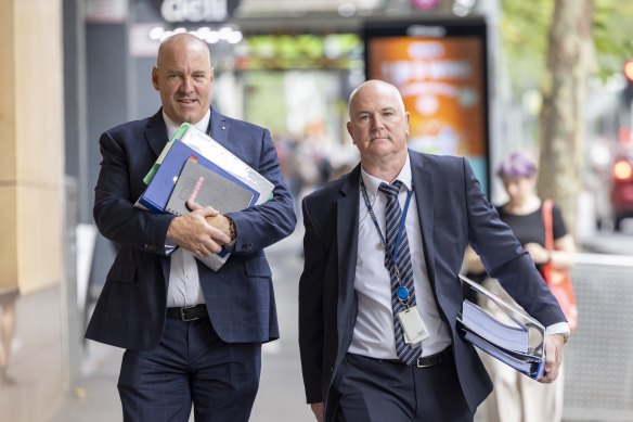 Detective Leading Senior Constable Daniel Passingham (left) and Detective Sergeant Brett Florence, from the missing persons sqaud, outside Melbourne Magistrates’ Court on Monday.