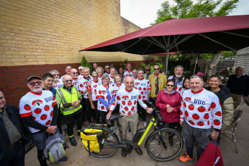 With help from his friends, Kelvin Chamier, holding his bicycle, at his 96th birthday party in Mont Albert.