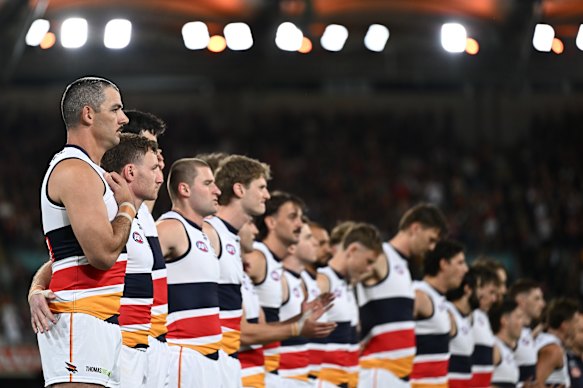 Taylor Walker of the Crows and team mates sing the national anthem in the pre-game.