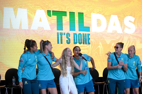 Sam Kerr and her history-making teammates sing along with Nikki Webster at Brisbane’s Riverstage on Sunday.