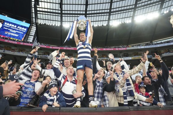 Joel Selwood takes to the stands with the premiership cup.