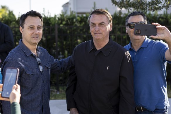 Former Brazilian president Jair Bolsonaro greets people outside the home where he’s staying in Kissimmee, Florida, on January 8