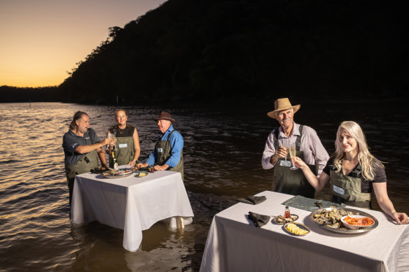 Sheridan Beaumont, right, and her father, Phil Barry-Cotter, second from right, run tours at their oyster farm north of Sydney.