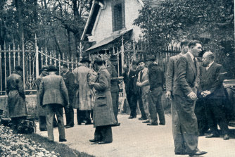 Photographers and journalists gather at the main entrance to the gates of the Chateau de Cande, the location of the wedding between Wallis Simpson and the abdicated King Edward VIII. 
