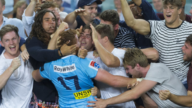 Rookie Waratahs forward Harry Johnson-Holmes celebrates with fans after NSW's thrilling win.