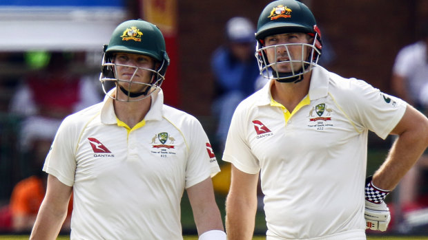 Steven Smith (left) with teammate Shaun Marsh, look on as the television umpires review his LBW appeal.