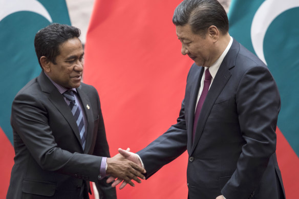 Maldives' President Abdulla Yameen, left, shakes hands with China's President Xi Jinping after a signing ceremony at the Great Hall of the People in Beijing.