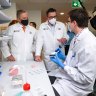 Anthony Albanese and Daniel Andrews in a laboratory at Monash University on Monday.