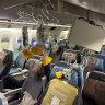 A traveller on the Singapore Airlines flight said some passengers “hit the places where lights and masks are and broke straight through it”.