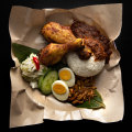 Nasi lemak kukus - coconut rice with peanuts, cucumber and hard-boiled egg, plus turmeric fried chicken and sambal calamari.