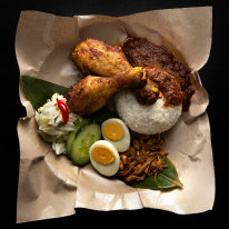 Nasi lemak kukus - coconut rice with peanuts, cucumber and hard-boiled egg, plus turmeric fried chicken and sambal calamari.