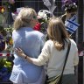 People lay flowers at the Adass Israel synagogue in Ripponlea on Sunday.
