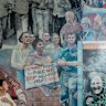 Judy Mundey looks up at a mural that shows her late husband Jack Mundey - in the upper right with a loudspeaker -  a leader of the Builders Labourer Federation and the green ban movement which saved the ’Loo for working-class people and defeated a proposal for highrise.