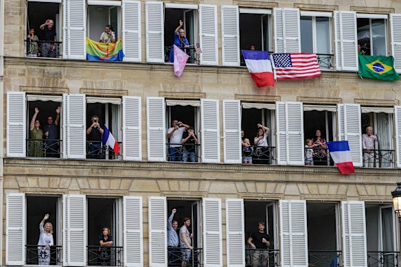 Spectators watch from balconies and windows. 