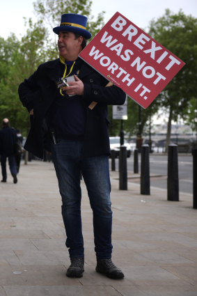 Protester Steve Bray holds a placard reading, “Brexit Was Not Worth It”, last year.