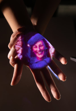 Home movies play out on a visitor’s hand in ACMI’s new Memory Garden.