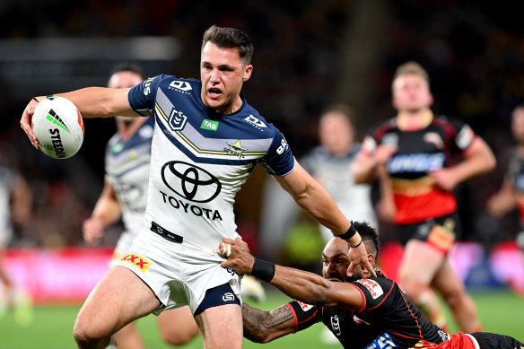 North Queensland’s Scott Drinkwater tries to give Hamiso Tabuai-Fidow the slip on Friday night.
