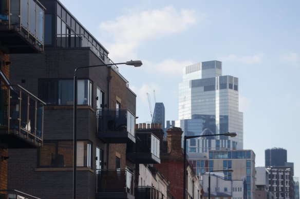 A block of residential flats near skyscrapers in the City of London.