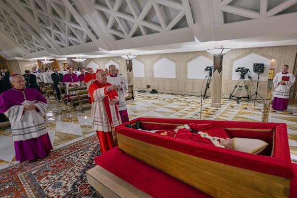 Cardinal Camerlengo Kevin Joseph Farrell, centre, performing the ceremonial aspersion of the body of Pope Francis with holy water as part of the final rites.