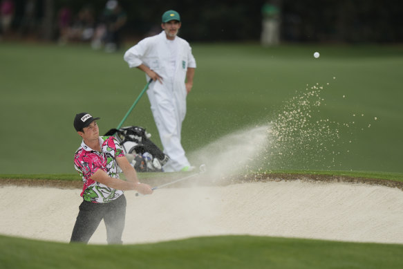 Shay Knight watches on as Viktor Hovland plays out of a bunker at The Masters.