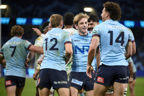 Max Jorgensen (centre) and Mark Nawaqanitawase (No.14) celebrate the latter’s try on Saturday night.