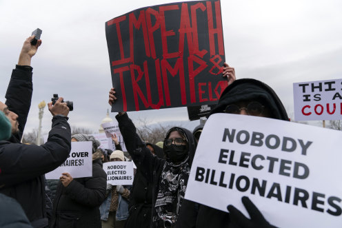 People protest during a rally against Elon Musk outside the US Department of Labour in Washington.
