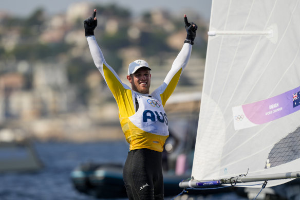 Matthew Wearn celebrates after winning the gold medal in men’s dinghy class final race.
