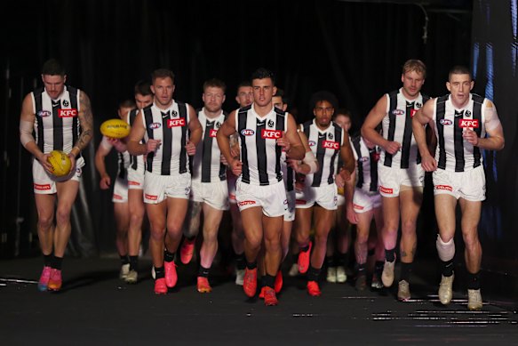 Nick Daicos of the Magpies leads the team out.
