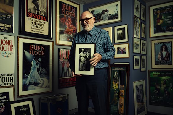 Harley Medcalf holding a photo of his younger self and the touring Dietrich.