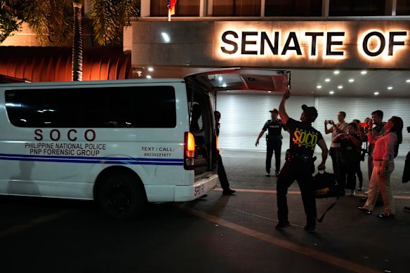 A police forensic team arrives at the Senate after the shooting.
