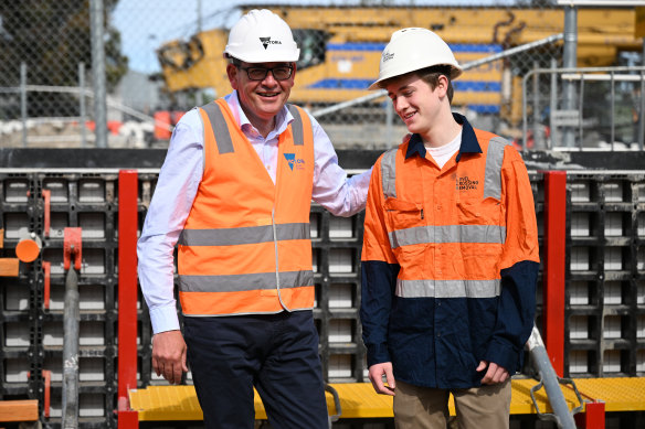 Victorian Premier Daniel Andrews (left) and son Joseph pose for photos during a visit to the Glen Huntly level crossing removal site.