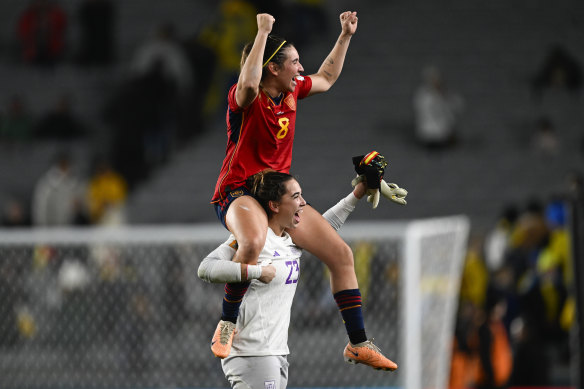 Spain’s goalkeeper Cata Coll carries teammate Mariona Caldentey as they celebrate victory over Sweden.